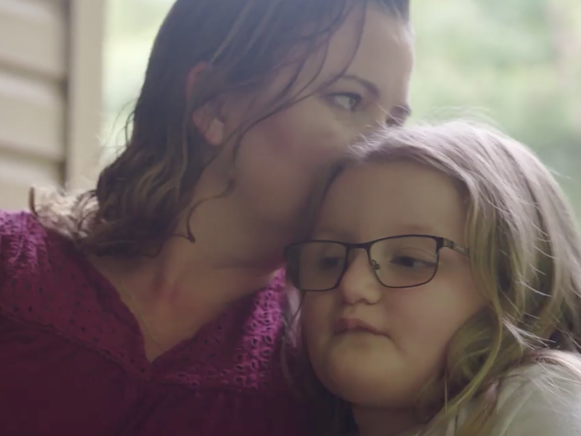 Woman kissing child's head